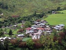 A distant view of the small rural village of Rukubji, Bhutan and the surrounding hills and fields